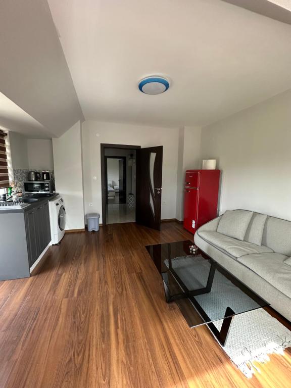 a living room with a couch and a kitchen at Varna Vinitsa in Varna City
