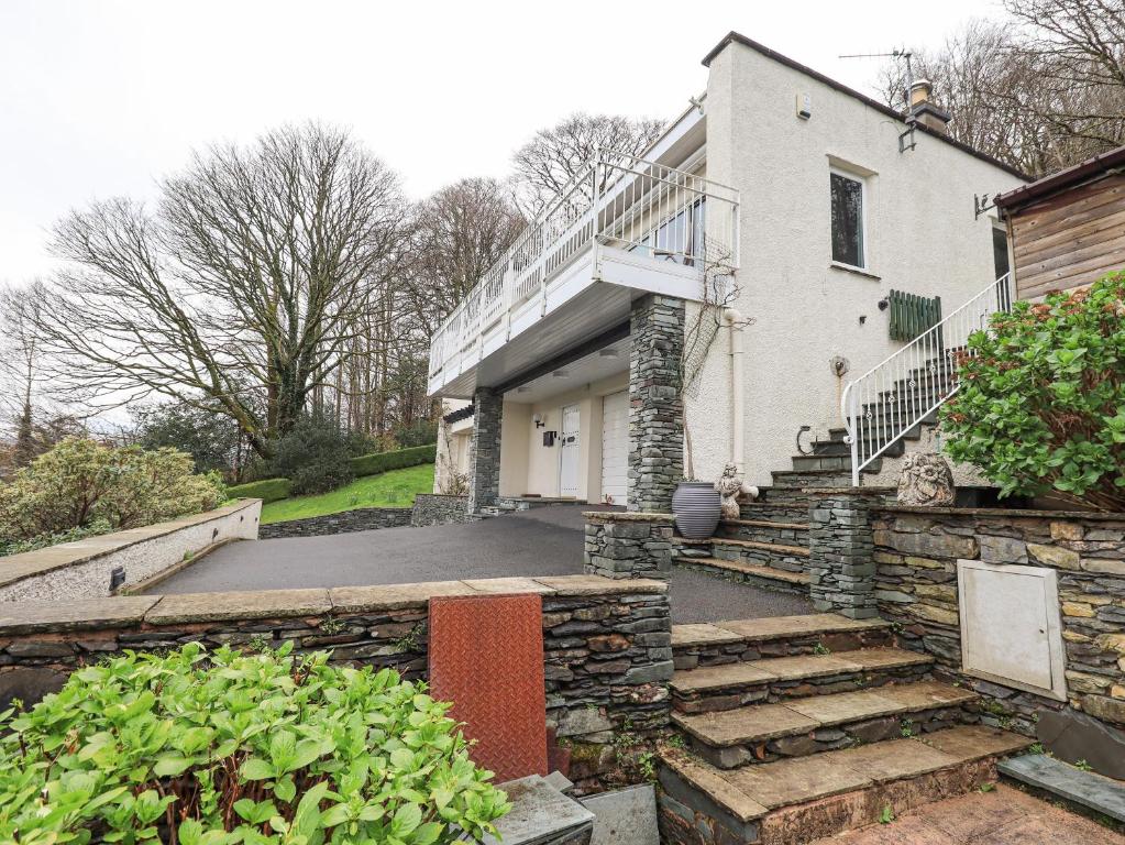 a house with a stone staircase leading to the front entrance at Tanna Hill in Bowness-on-Windermere
