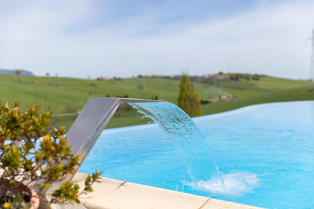 a water fountain in a pool of water at B&B Casa Fanny Riviera Del Conero in Loreto