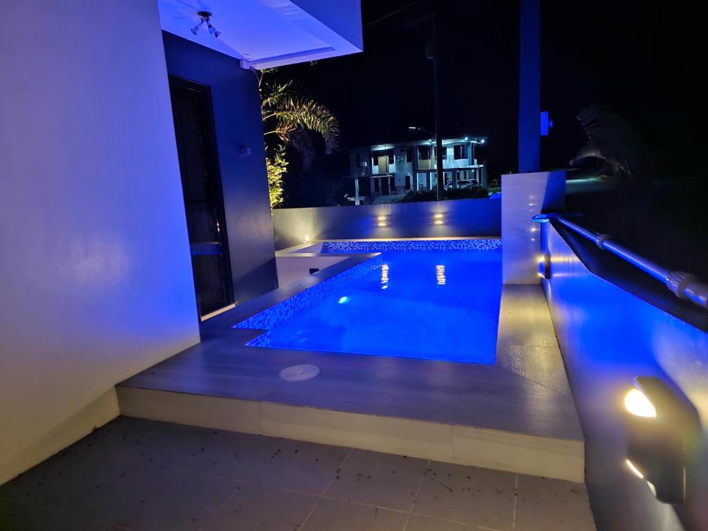 a house with a swimming pool at night at Staycation @ Sandari Batulao in Tagaytay