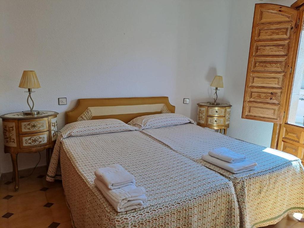 a bedroom with a bed with two towels on it at WAXSIMA Burgo de Osma in Osma