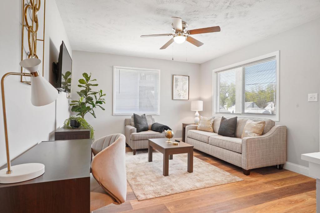 a living room with two couches and a ceiling fan at Capital Retreat: Idyllic 2BD, 1BA Gem in Springfield Medical District! in Springfield