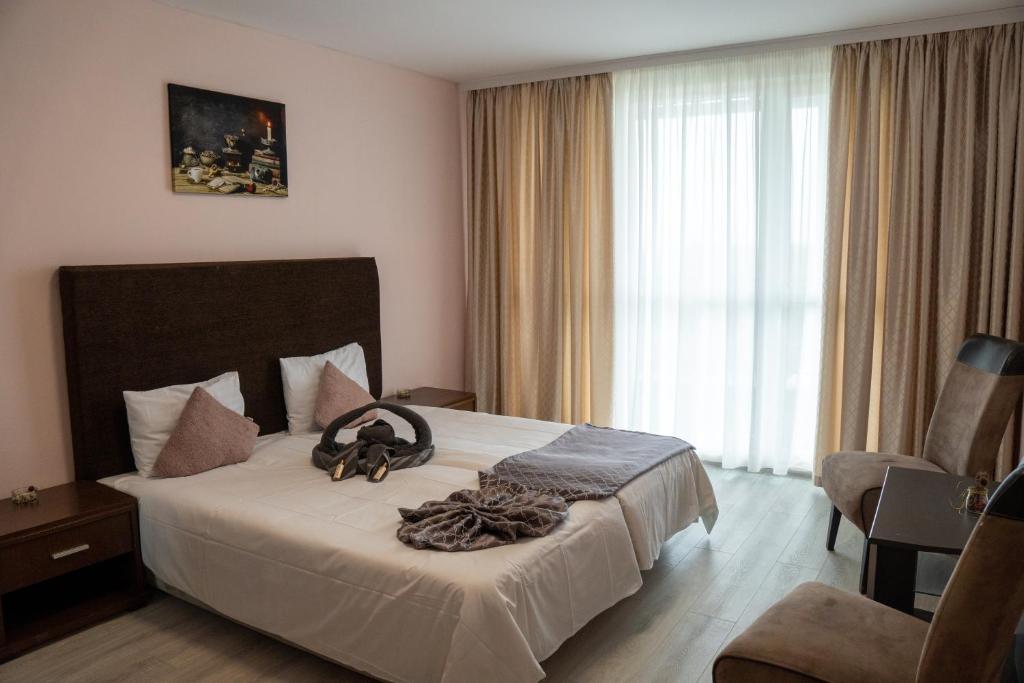 クラネヴォにあるSunny Apartments Kranevoの大きな窓付きのベッドが備わるホテルルームです。