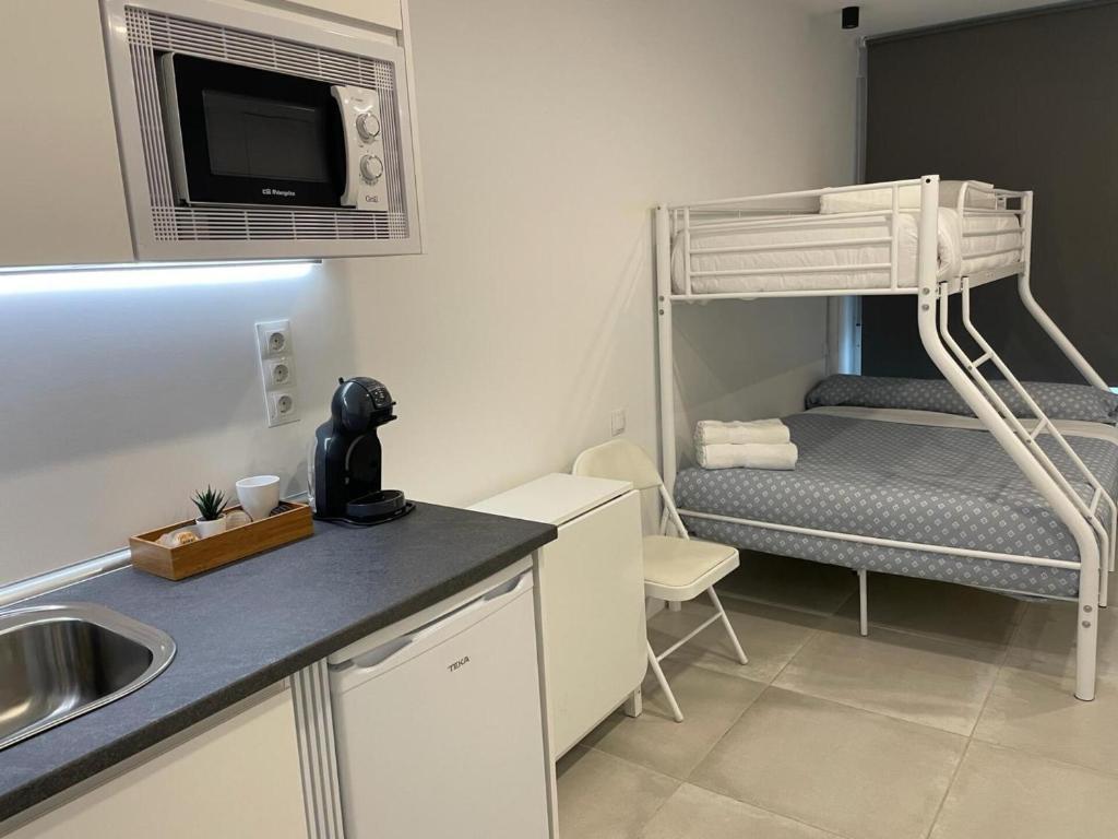 una pequeña cocina con litera y fregadero en C10 Exclusiva zona Madrid cerca Bernabéu en Madrid
