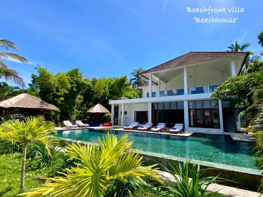 a swimming pool in front of a villa at Paradise West-Bali in Palasari