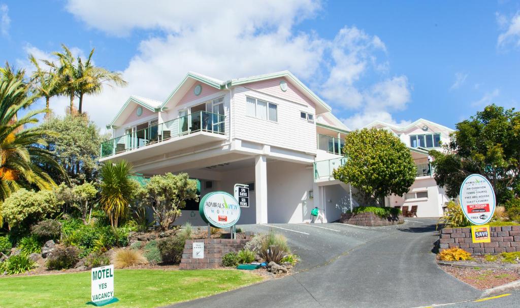 a house with a sale sign in front of it at Admirals View Lodge in Paihia