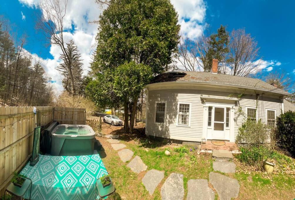 a small house with a boat in the yard at Long Mountain Suite W/Hot tub in Amherst