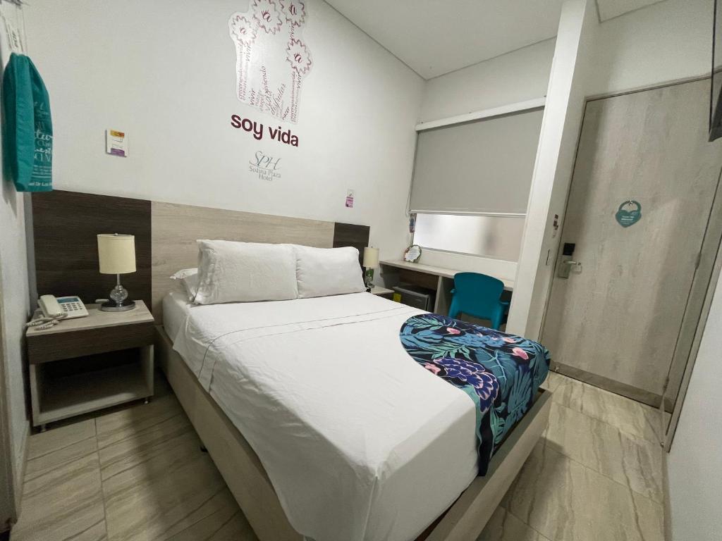 Postel nebo postele na pokoji v ubytování Hotel Sixtina Plaza Medellin