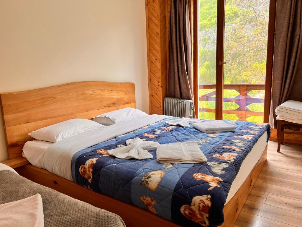 a bedroom with a bed with towels on it at Bujtina Polia in Theth