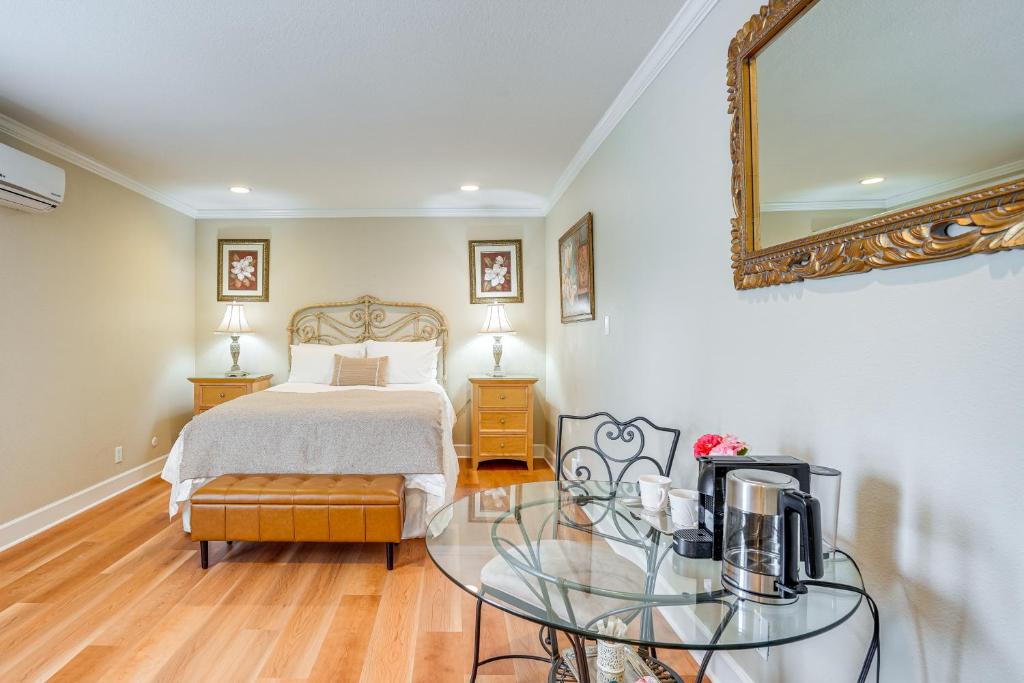 a bedroom with a bed and a glass table with a tv at Resort-Style Napa Studio Close to Wineries! in Napa
