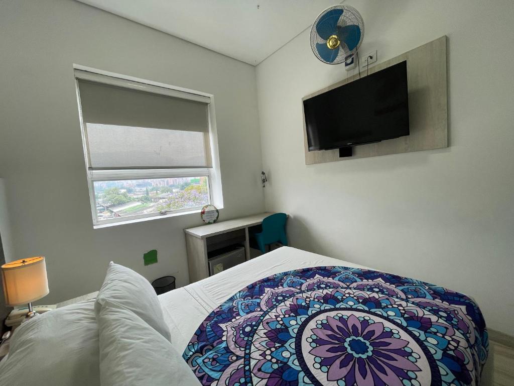 Postel nebo postele na pokoji v ubytování Hotel Sixtina Plaza Medellin