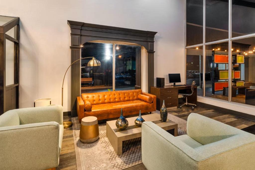 a living room with a couch and two chairs at Sleepover Nashville Studio Apartments in Nashville