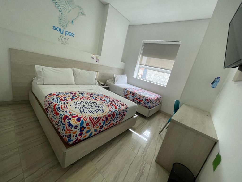 Postel nebo postele na pokoji v ubytování Hotel Sixtina Plaza Medellin
