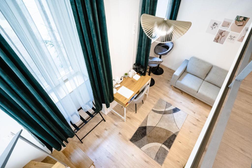 an overhead view of a living room with a table and a chair at Kalvin Apartments in Budapest