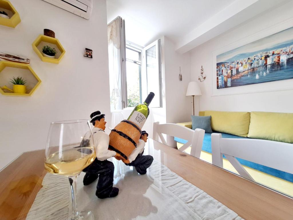 a toy man holding a bottle of wine in a living room at Apartment Megi in Supetar historical core in Supetar