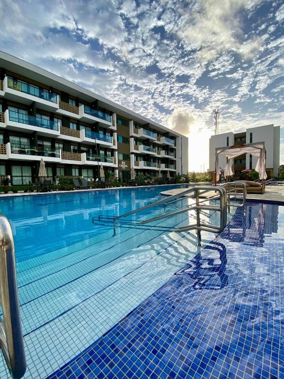 a large swimming pool in front of a building at Mana Beach Experience B019 in Porto De Galinhas