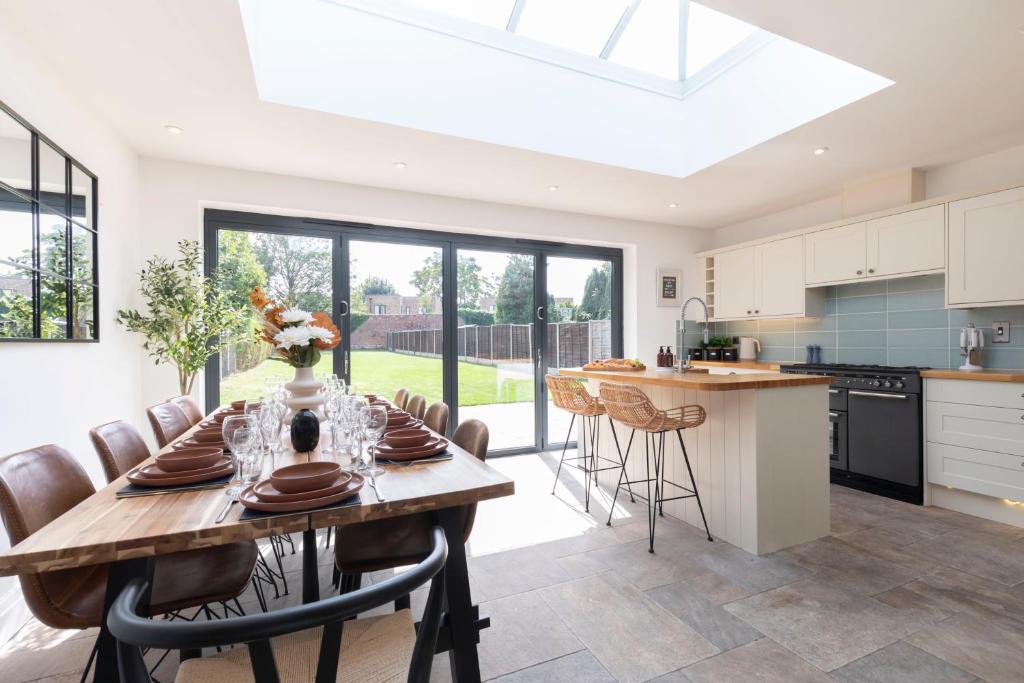 a kitchen and dining room with a table and chairs at Lythwood House in Gloucester