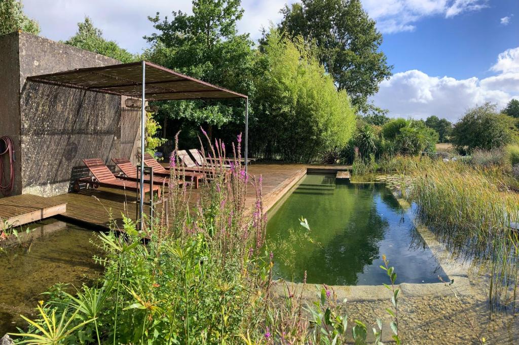 um lago com cadeiras e um pavilhão num jardim em Domaine de La Beurrerie, déconnectez Naturellement em Saint-Mesmin