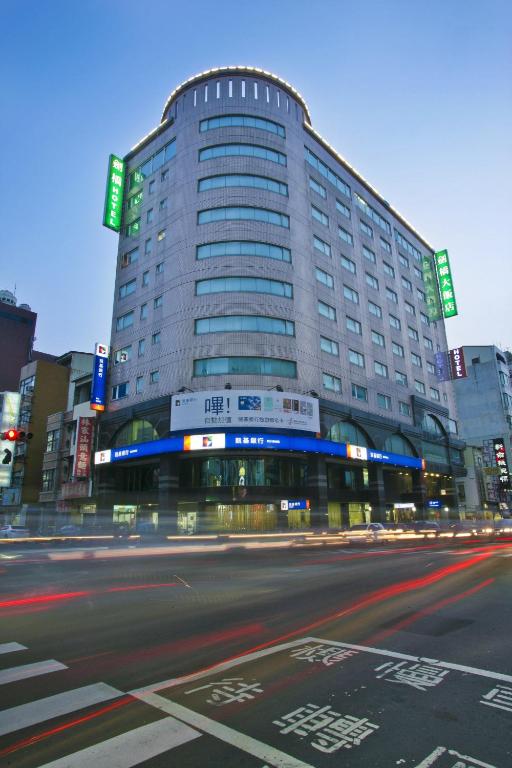 a large building on the side of a city street at Cambridge Tainan Hotel in Tainan