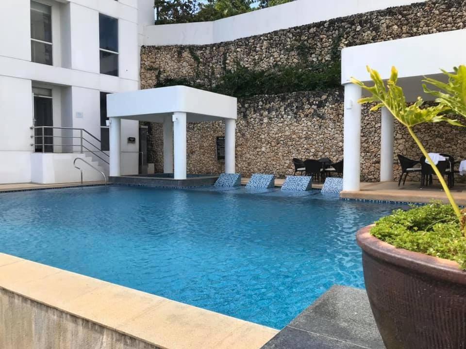 a large swimming pool with blue water in front of a building at The Nest in Oceanway Boracay in Boracay