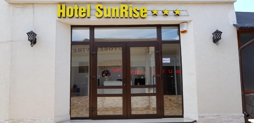 a building with a hotel sunrise sign and a door at SunRise in Venus