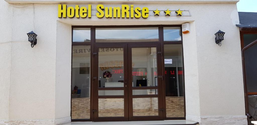 a building with a hotel sunrise sign and a door at SunRise in Venus