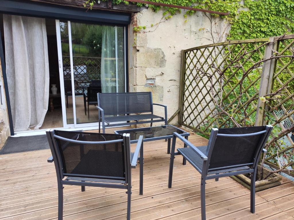 2 sillas y una mesa en una terraza en Halte vendéenne atypique, en Saint-Germain-lʼAiguiller