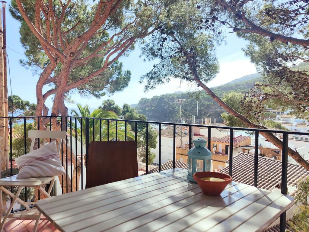 a table on a balcony with a view of a mountain at Tamariu Roca Rubia 1- cozy terrace and balcony with views of the seavilla in Tamariu