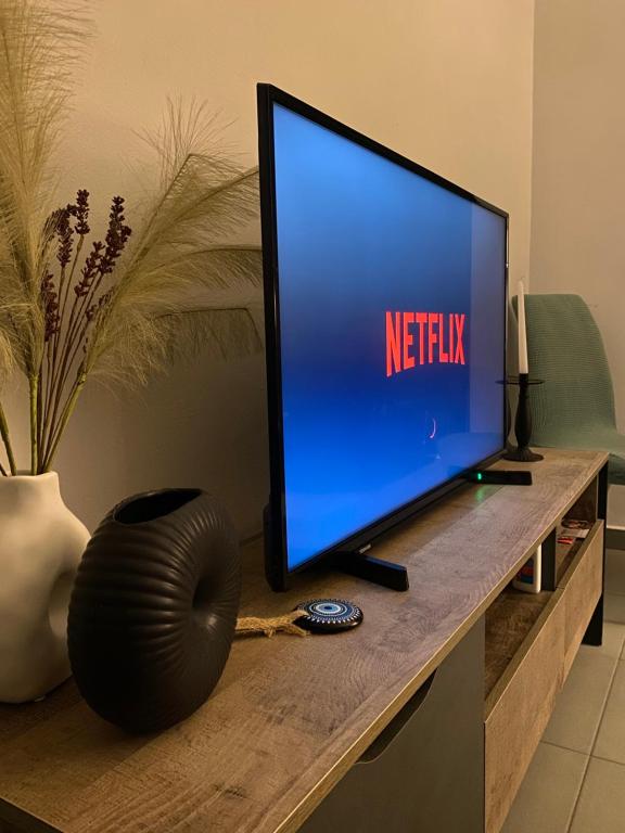 a television sitting on a desk with the netflix sign on it at D & A house 150m from Chalandri metro station in Athens