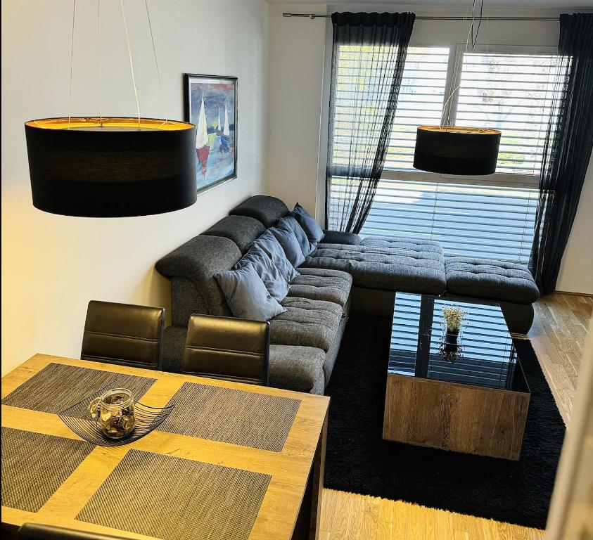a living room with a couch and a table at Brand New Apartment, Top Location-Near VIC/Danube in Vienna