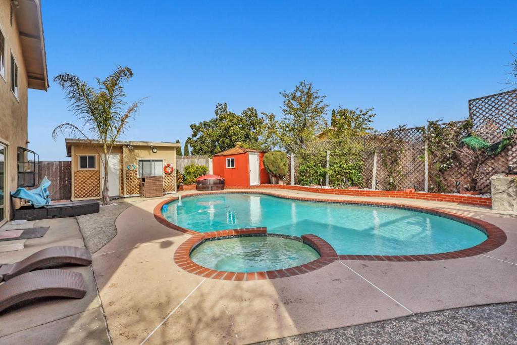 a large swimming pool in a yard at Colorful and Cozy Haven with Heated Pool in Rodeo