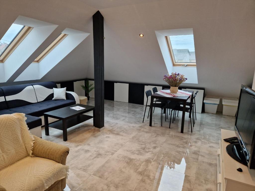 a living room with a couch and a table at Apartament KNIEJA LUX in Tuchola