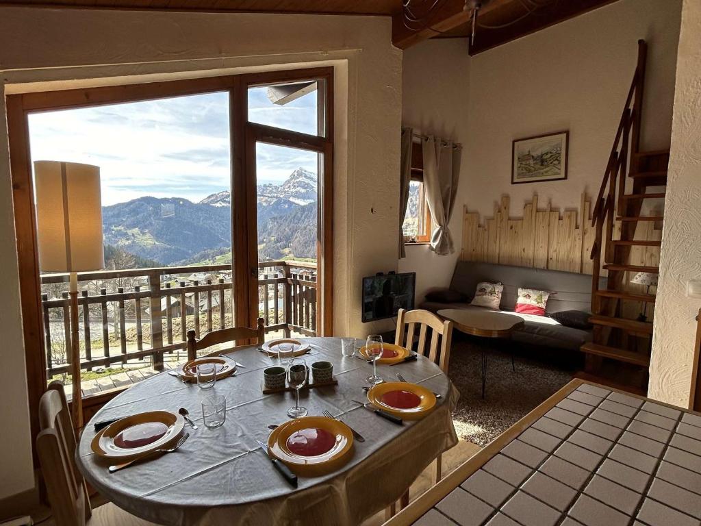 a room with a table with a view of a mountain at Appartement Notre-Dame-de-Bellecombe, 2 pièces, 6 personnes - FR-1-595-27 in Notre-Dame-de-Bellecombe