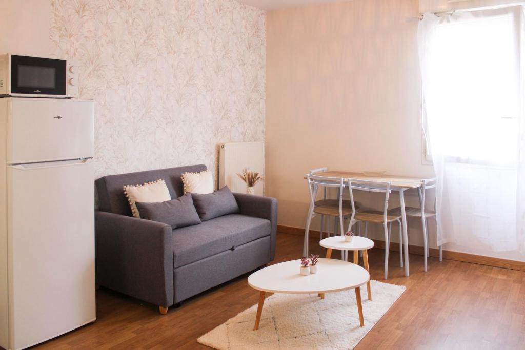 - un salon avec un canapé et une table dans l'établissement Bright and well-decorated family apartment, à Bagnolet