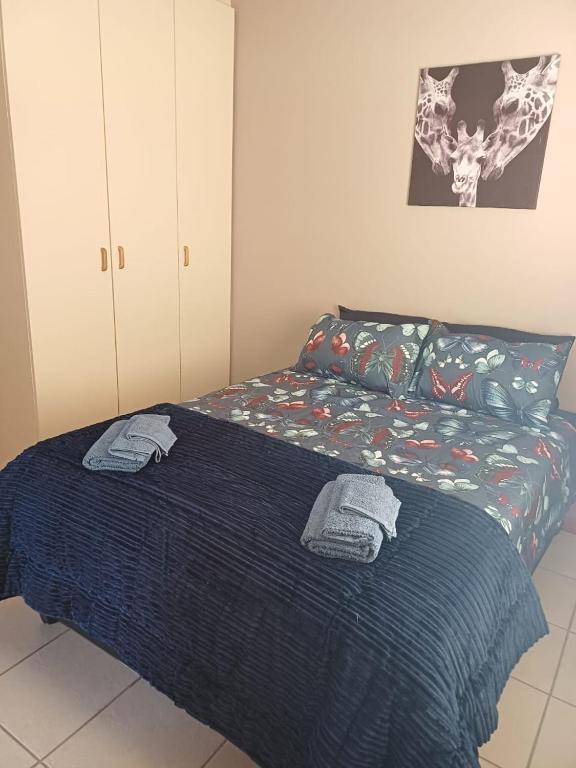 a bedroom with a bed with towels on it at Leipoldt street 3 in Clanwilliam