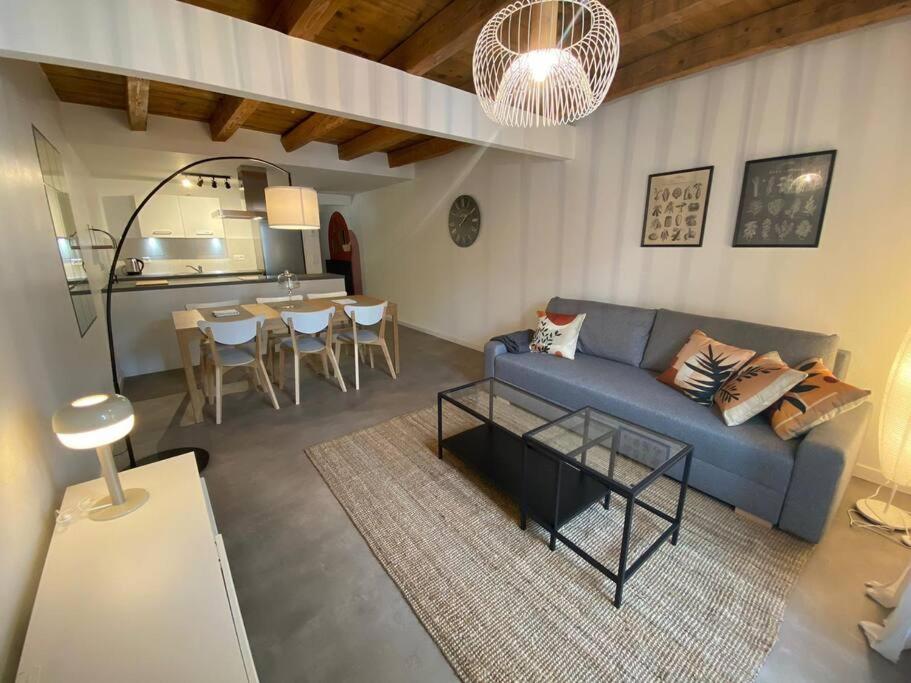 a living room with a blue couch and a table at Sympathique T3 cœur de village in Viuz-en-Sallaz