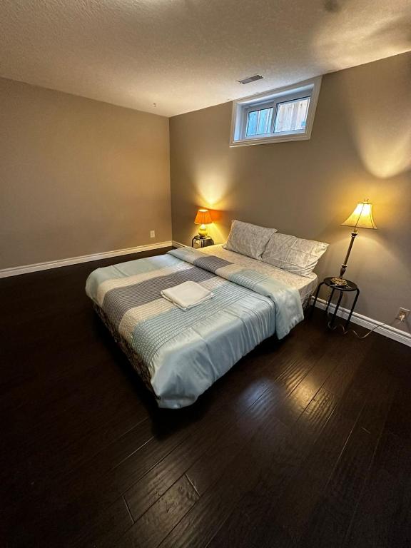 a bedroom with a large bed with a window at Pocket Friendly Room-Plaza, bus stop walking distance!3 in Kitchener