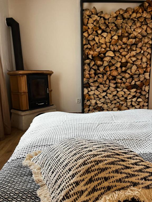 a bedroom with a bed and a pile of fire wood at Mohelenský dvůr in Mohelno