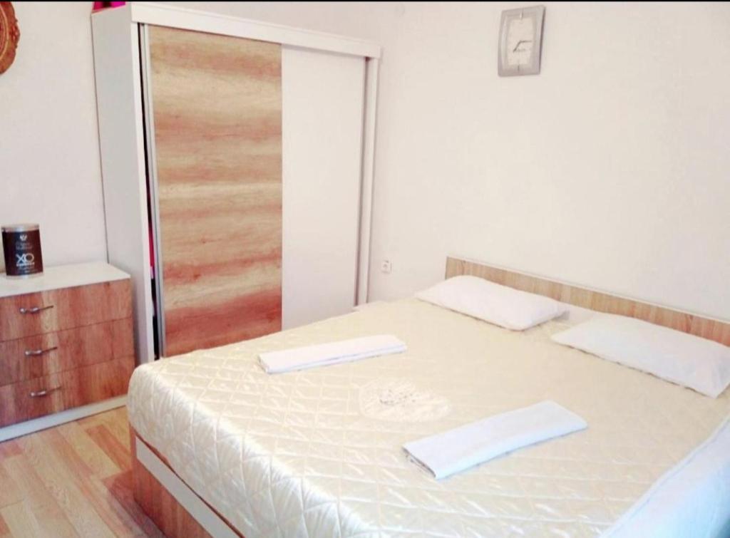 a bedroom with a bed with two towels on it at Urban Hostel in Peje
