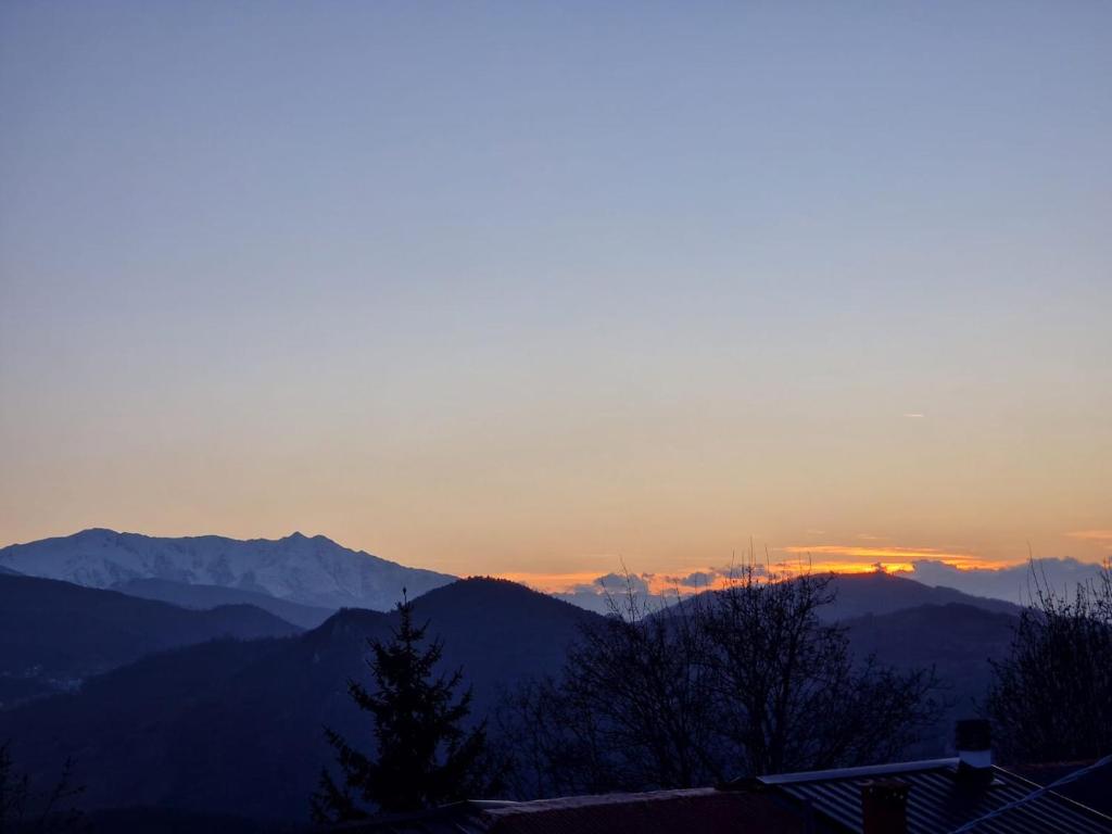 a sunset with mountains in the background at Profumo di montagna San Giacomo di roburent in San Giacomo