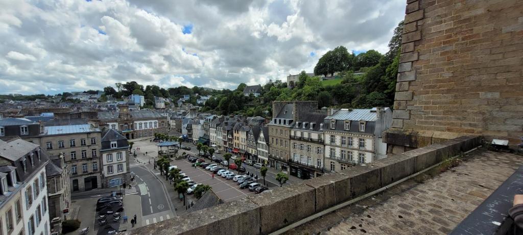 a view of a city with cars and buildings at Au Pied du Viaduc in Morlaix