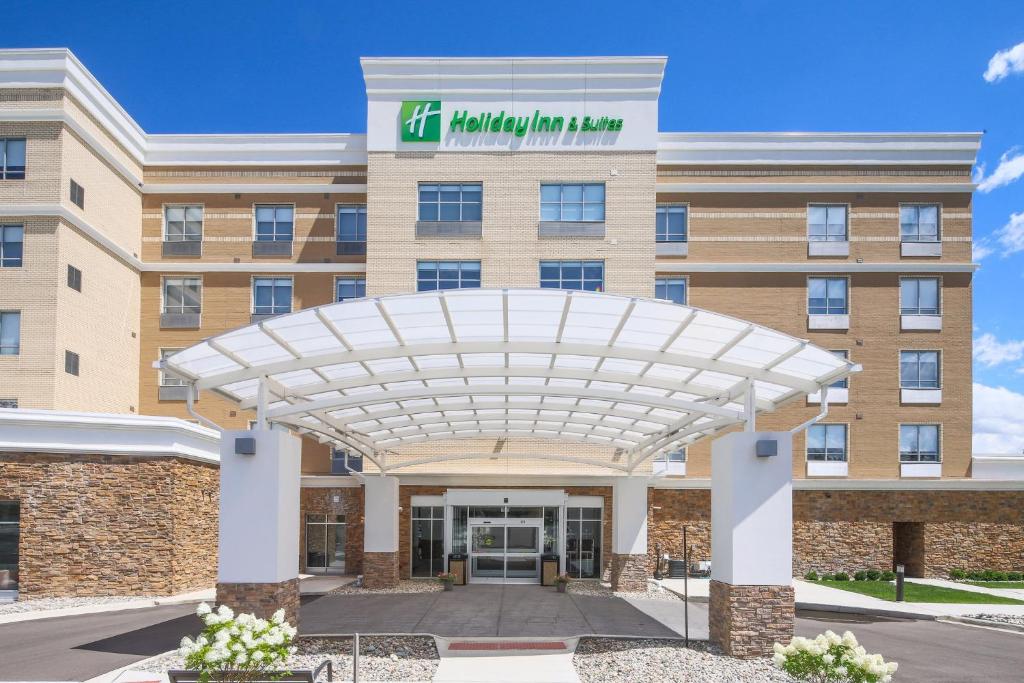 a rendering of the front of a hotel with a building at Holiday Inn & Suites Detroit - Troy, an IHG Hotel in Troy