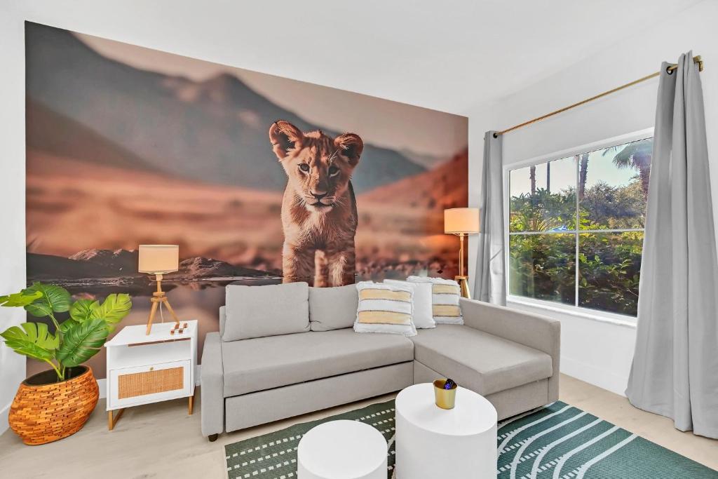 a living room with a lion on the wall at Boho Oasis 1 mile Disney Springs in Orlando