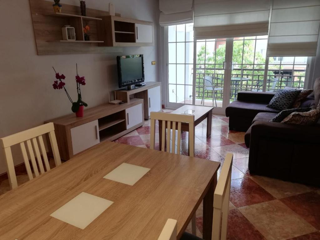 a living room with a table and a couch at Apartamento Olivia in Nerja