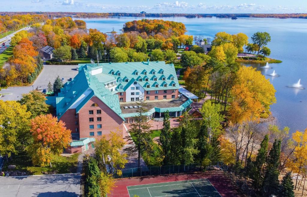 an aerial view of a large house with a green roof at Chateau Vaudreuil in Vaudreuil-Dorion