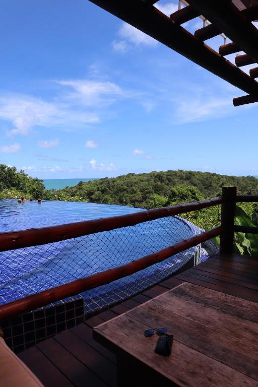 a view of a river from a balcony with a view at Bangalô Villas do Pratagy in Maceió