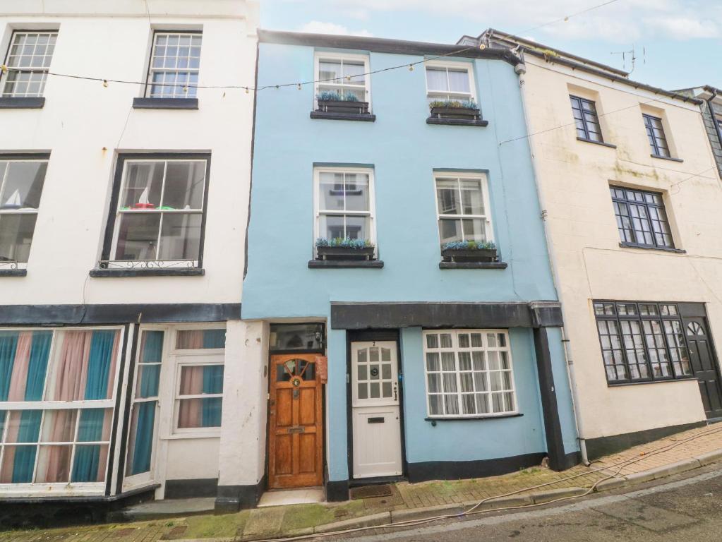 a blue house on the corner of a street at Harbour Cottage in Ilfracombe