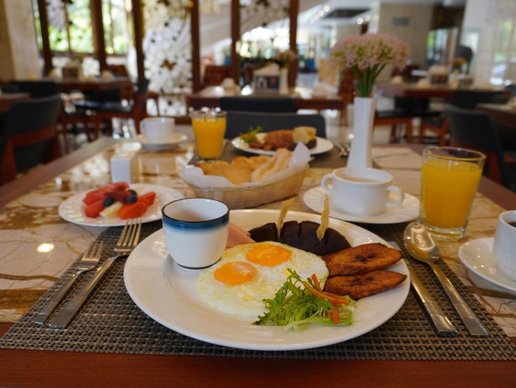 a table topped with plates of eggs and toast at Hotel Vista Quince in Guatemala