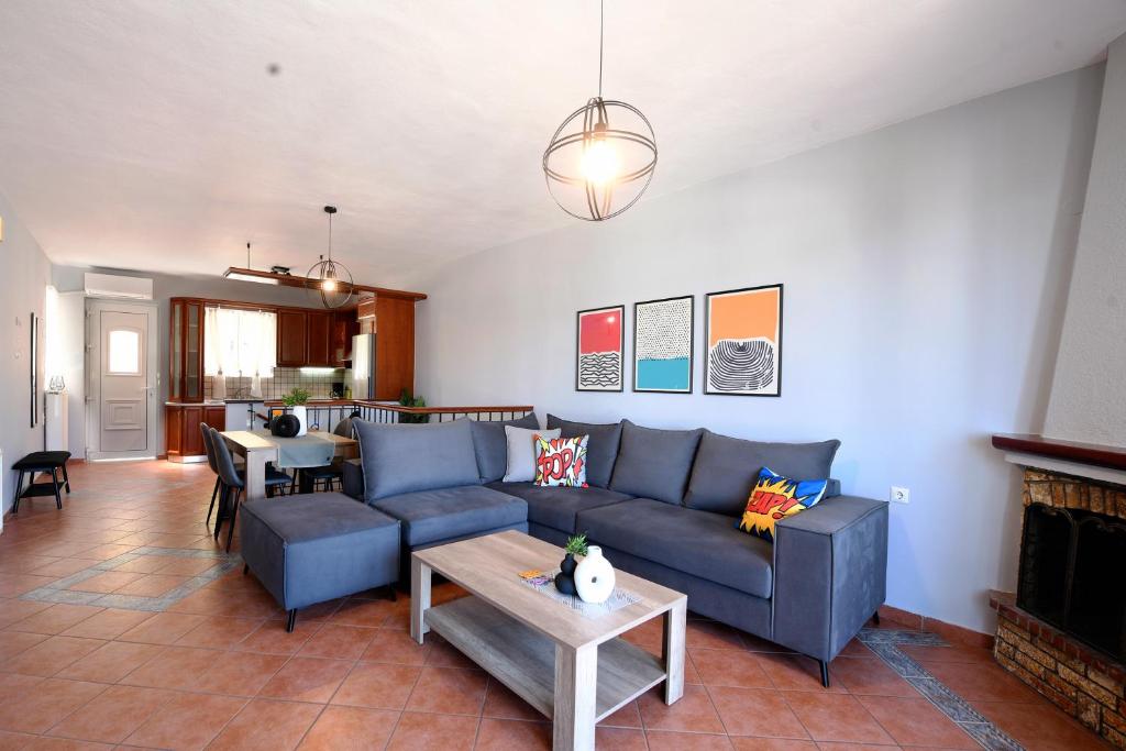a living room with a couch and a table at Our Happy Place Maisonette in Kavala
