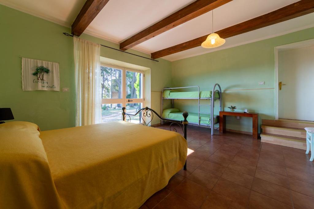 a bedroom with a yellow bed and a window at Il Tremolar Della Marina in Casalbordino